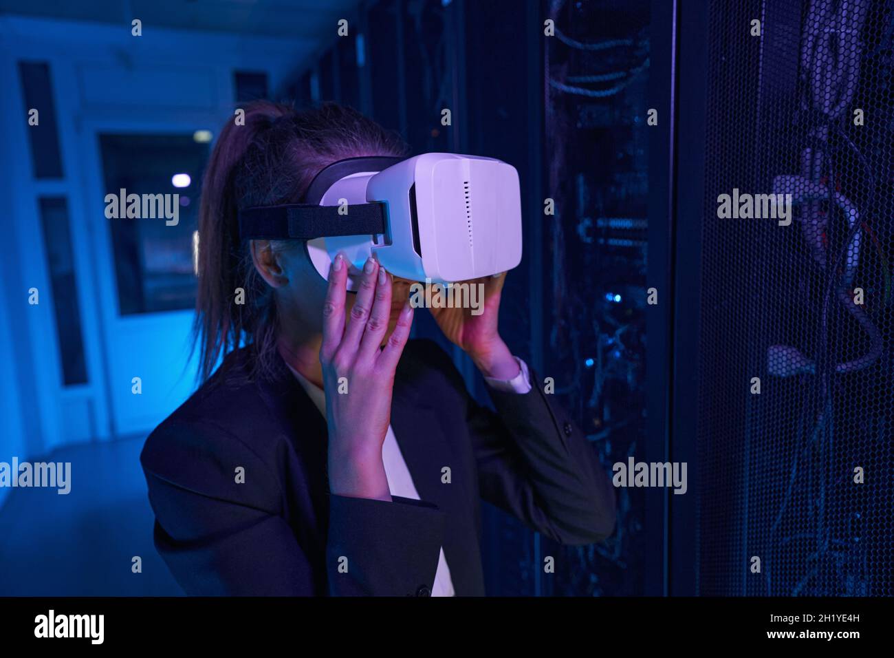 Woman is using VR headset in data center Stock Photo