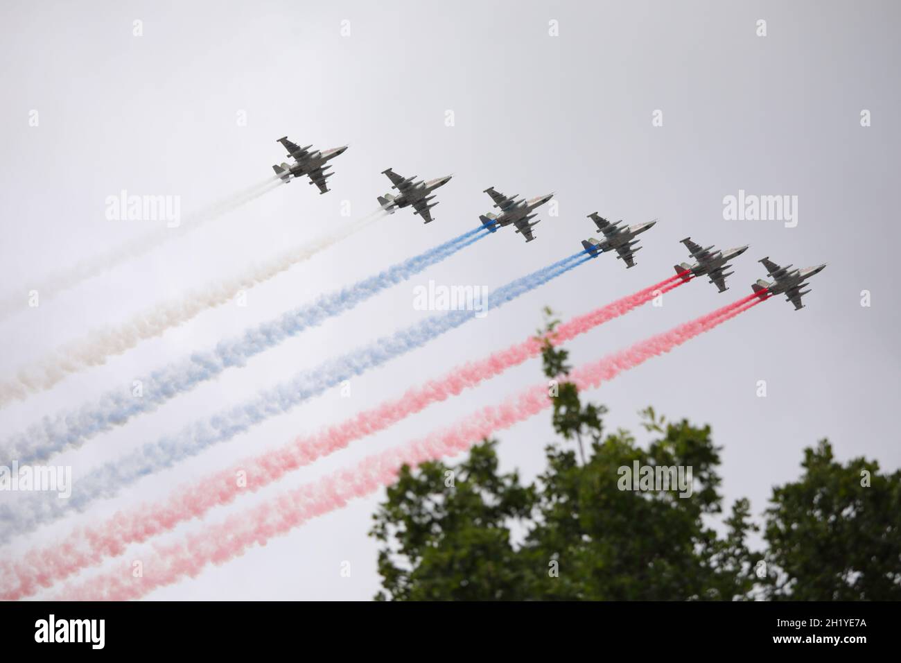 Six planes of naval aviation draw the national flag of Russia in the sky over St. Petersburg, Russia during the rehearsal of Russian Navy Day parade Stock Photo