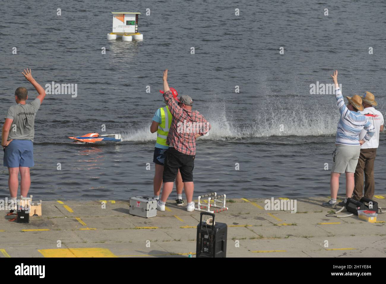 Competitors watch semifinal races of radio-controlled FSR-class model racing boat during Russian Shipmodelling Sport Championship Stock Photo