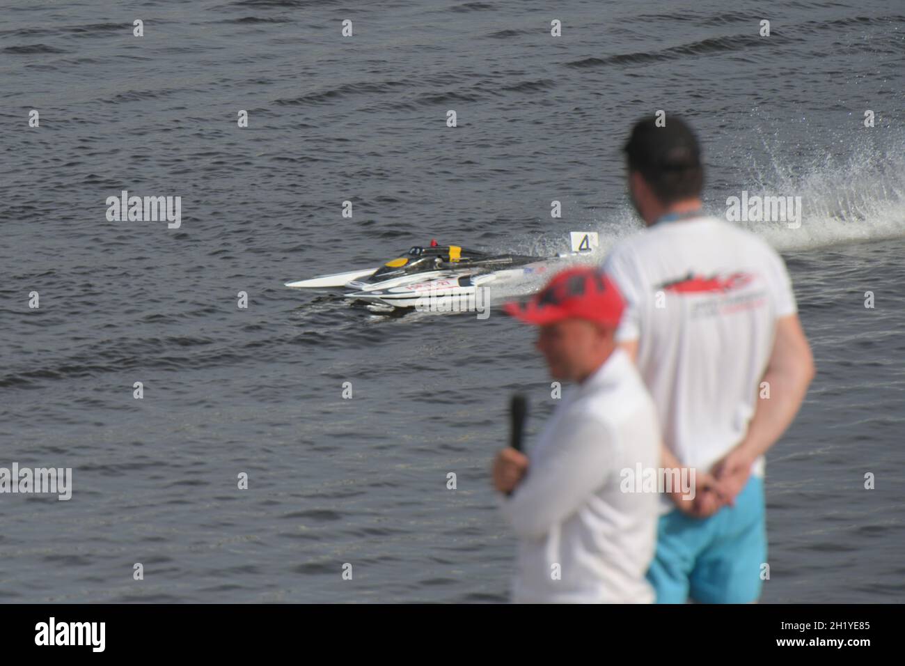 Competitors watch semifinal races of radio-controlled FSR-class model racing boat during Russian Shipmodelling Sport Championship Stock Photo