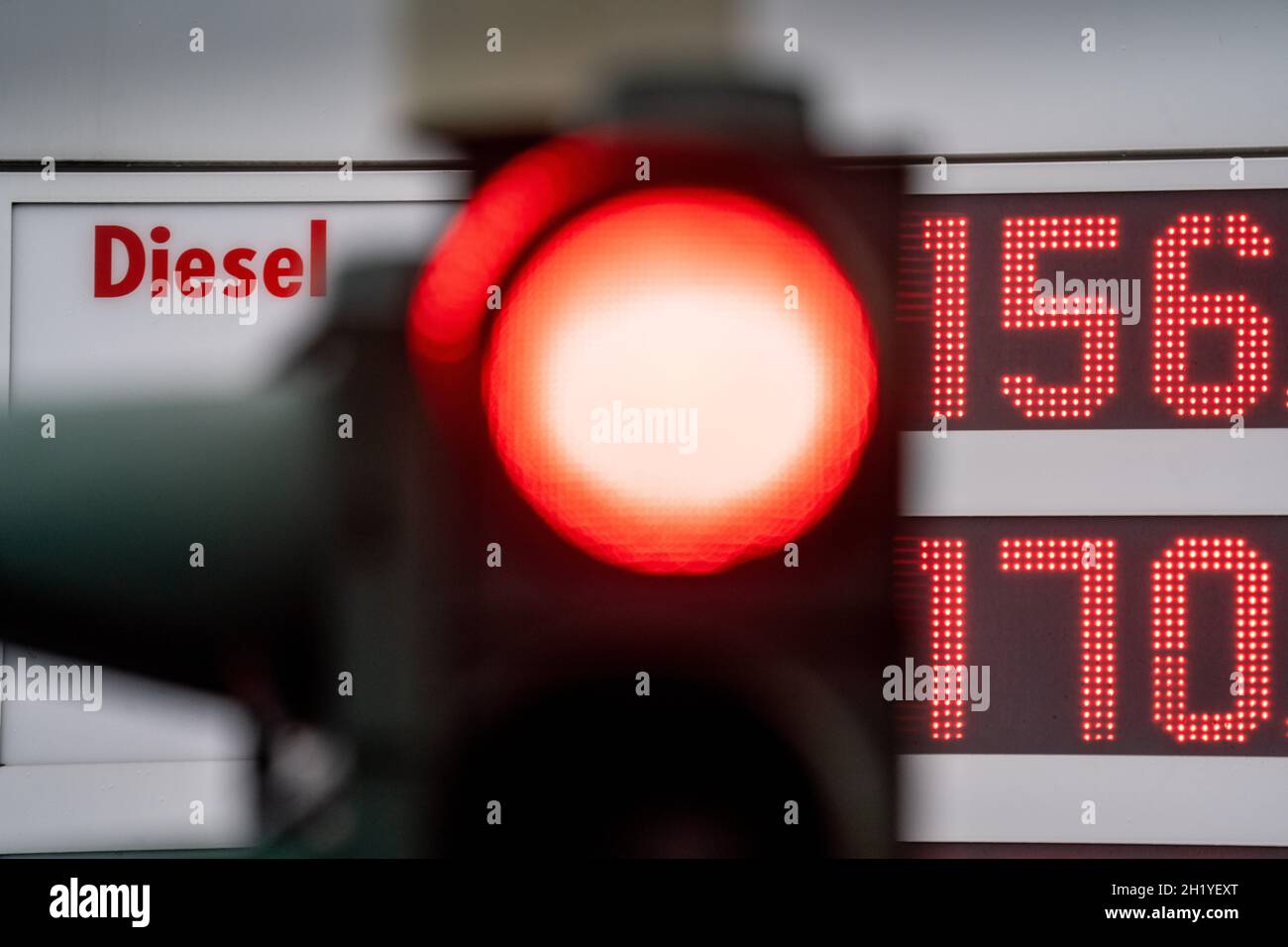 19 October 2021, Hessen, Frankfurt/Main: A red light shines in front of the price board at a gas station. Rising oil prices have been driving up costs at the pump for months. Now diesel has broken its nine-year-old price record. Photo: Frank Rumpenhorst/dpa Stock Photo