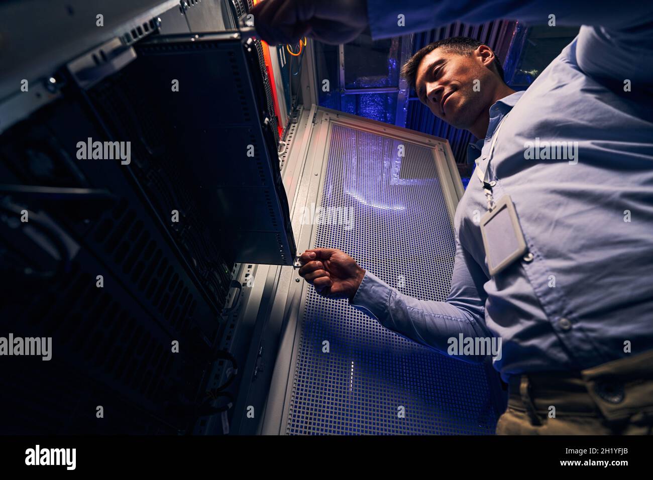 IT professional focused on replacing blade server Stock Photo