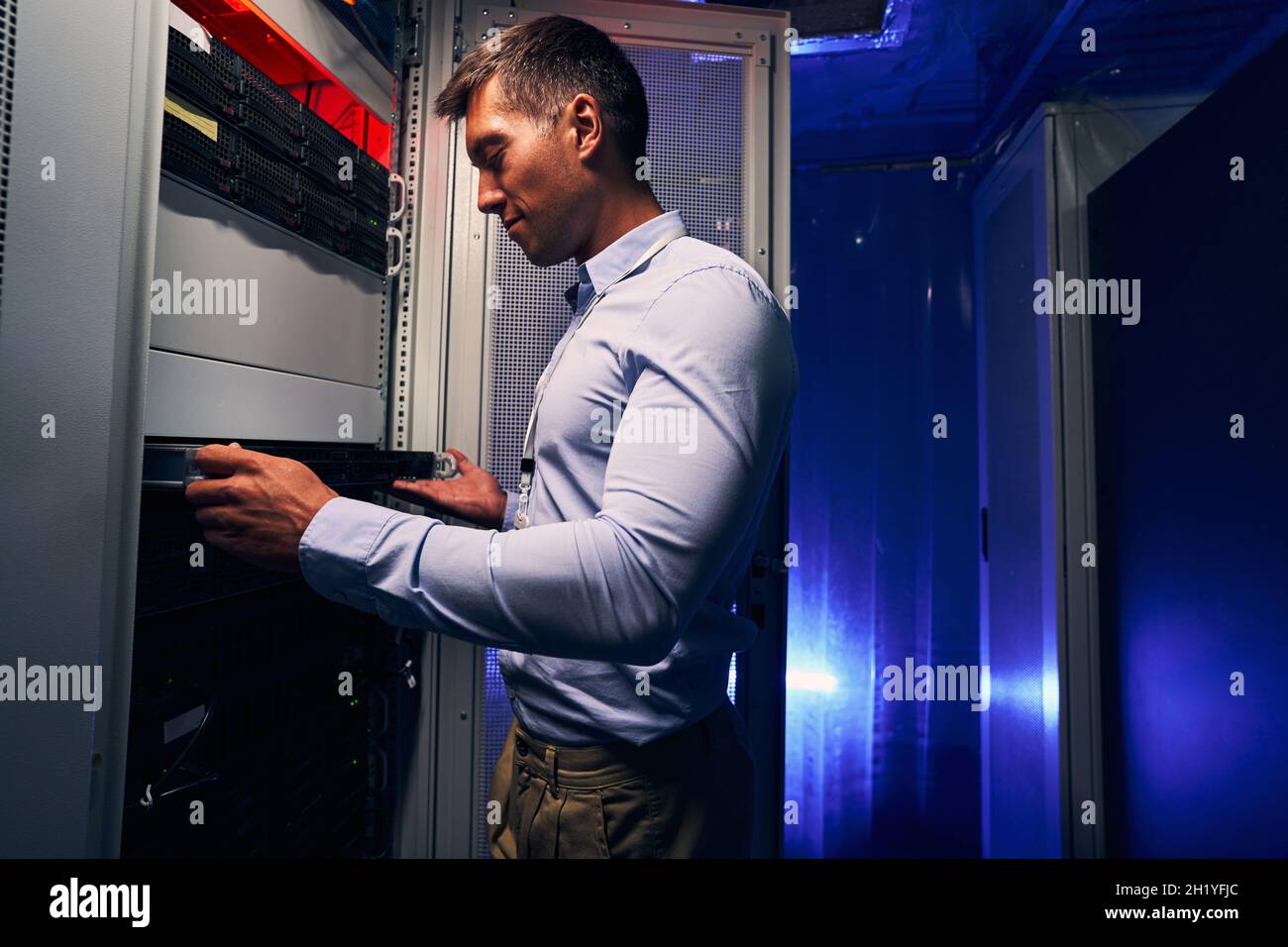 Experienced Caucasian IT technician upgrading computer hardware Stock Photo