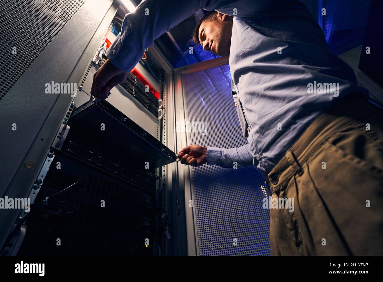 IT engineer replacing old equipment in data center Stock Photo