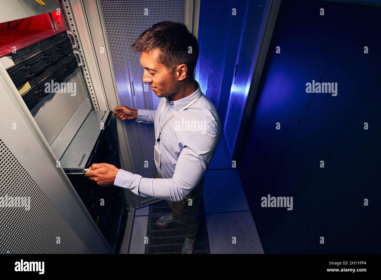 Expert male engineer replacing old hardware component Stock Photo