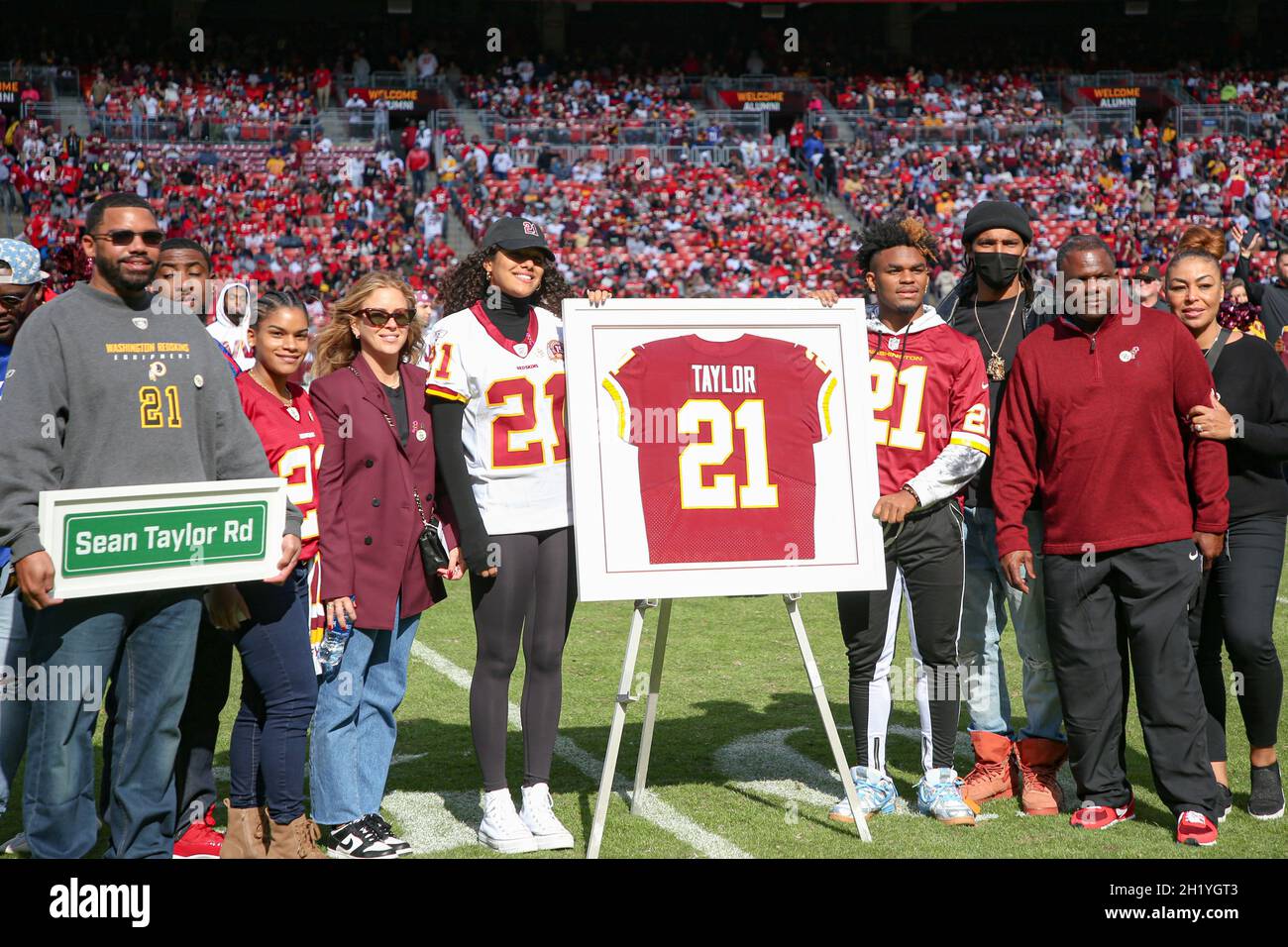 Sunday, October 17, 2021; Landover, MD, USA; Members of former Washington  Football Team safety Sean Taylor (21) pose for a photo during an NFL game  against the Kansas City Chiefs at FedEx