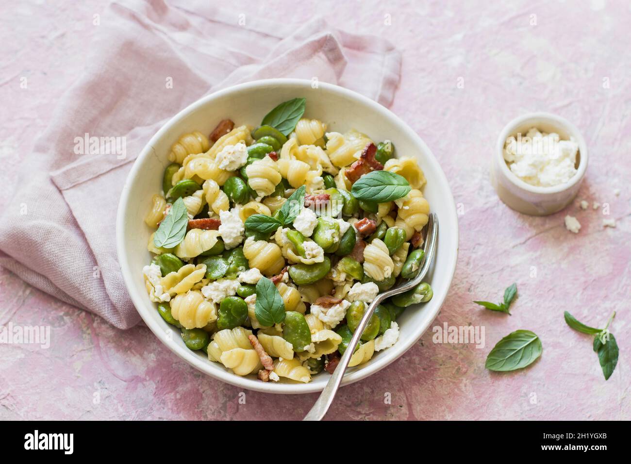 Pasta shells with broad bean, bacon, curd cheese and mint Stock Photo ...