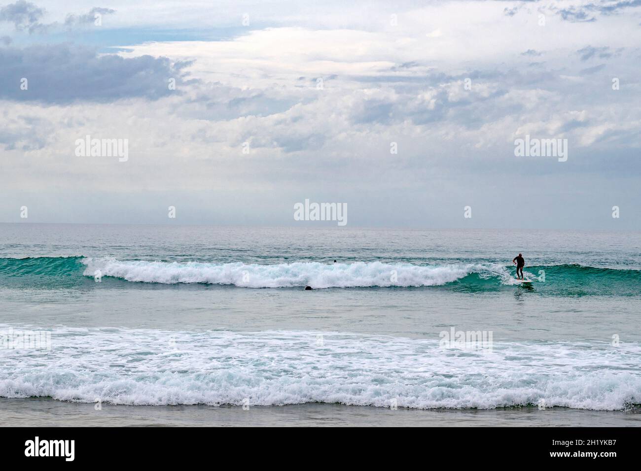 The main beach of Bidart - plage centrale or grande place - is a popular spot for surfers and bordered by clilffs, stretching along the Atlantic coast Stock Photo