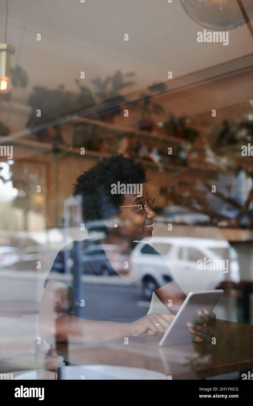 Conveniently wireless at her local cafe Stock Photo