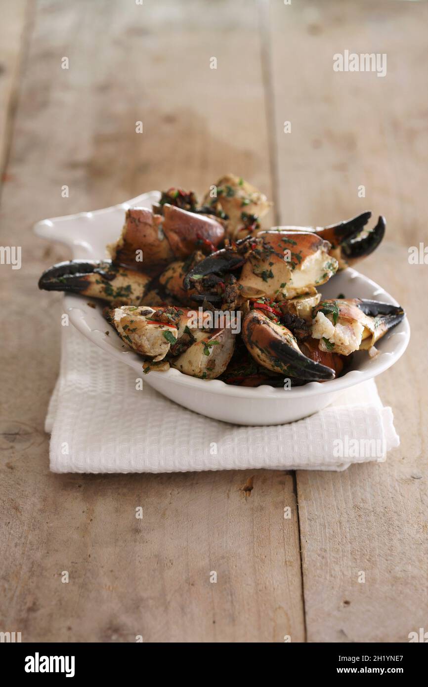 Crab claws with herb sauce Stock Photo Alamy