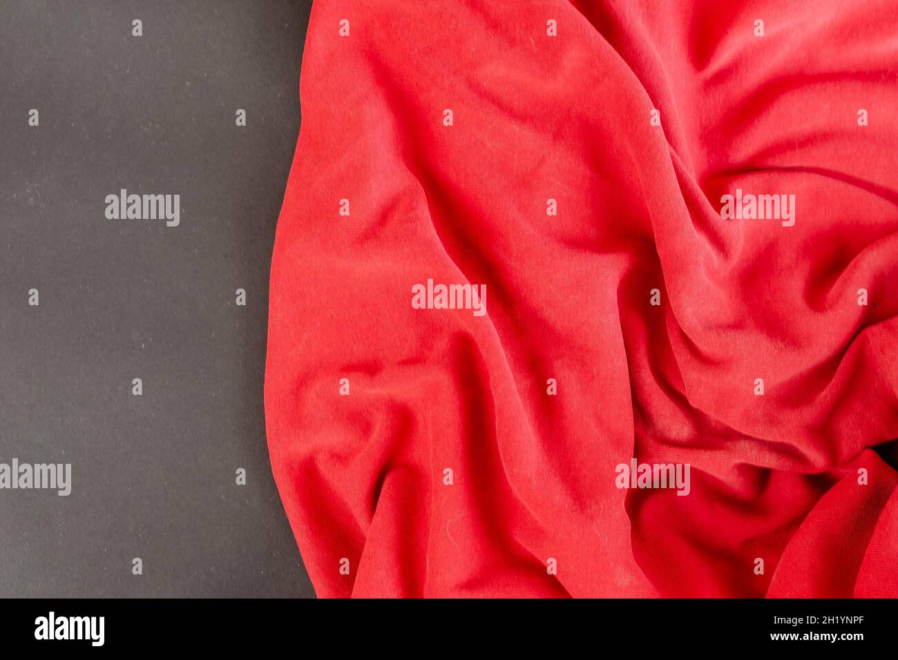 Red fabric against a black background. Angled view from above Stock ...