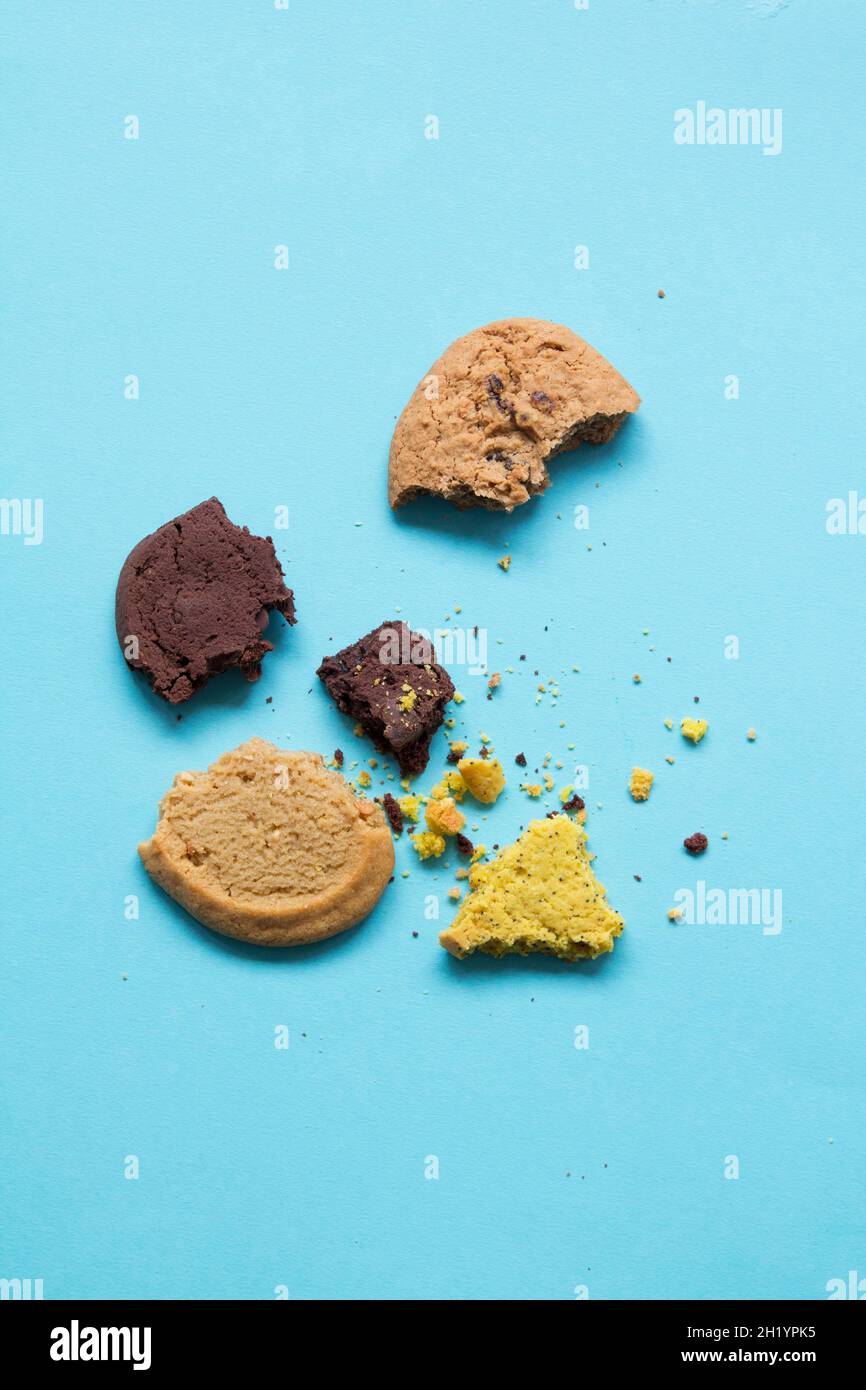 Broken biscuits on a light blue background Stock Photo Alamy