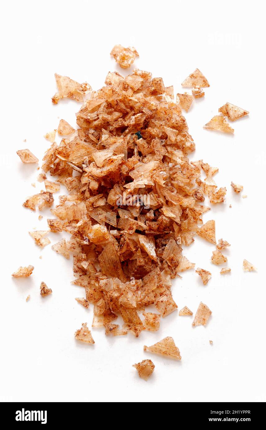 A heap of smoked salt on a white surface Stock Photo