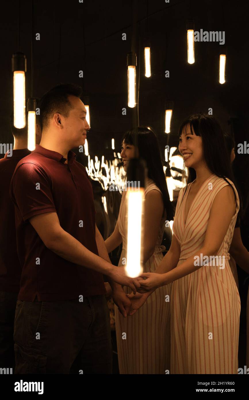 Couple hold hands look other hi-res stock photography and images - Alamy