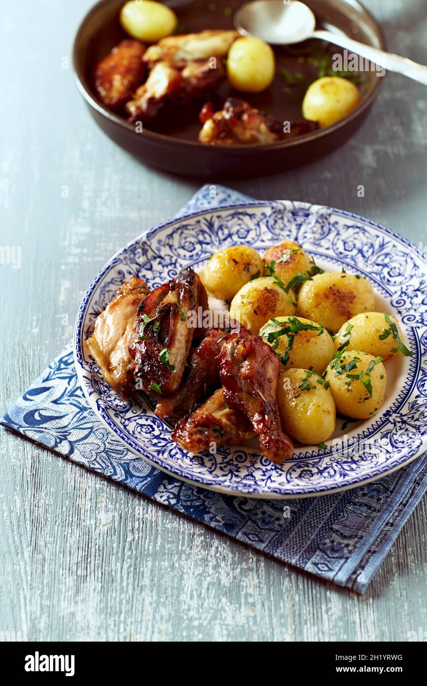 Honeyglazed chicken with ovenbaked potatoes Stock Photo Alamy