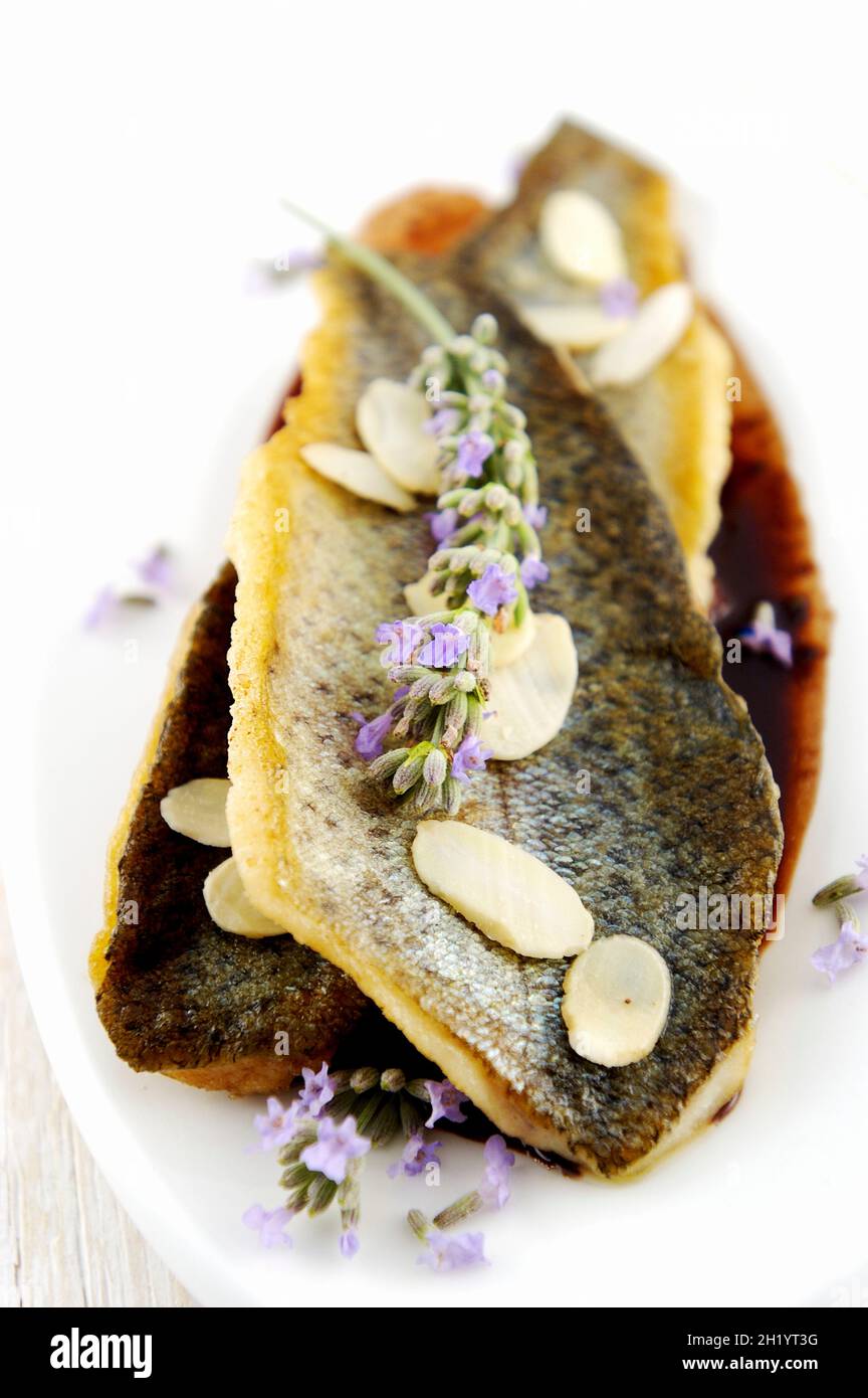 Trout in sauce with almonds and lavender Stock Photo