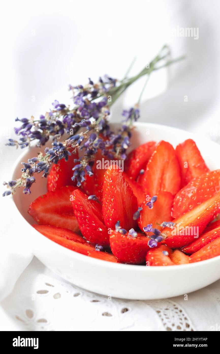 Strawberries with lavender syrup and lavender flowers Stock Photo