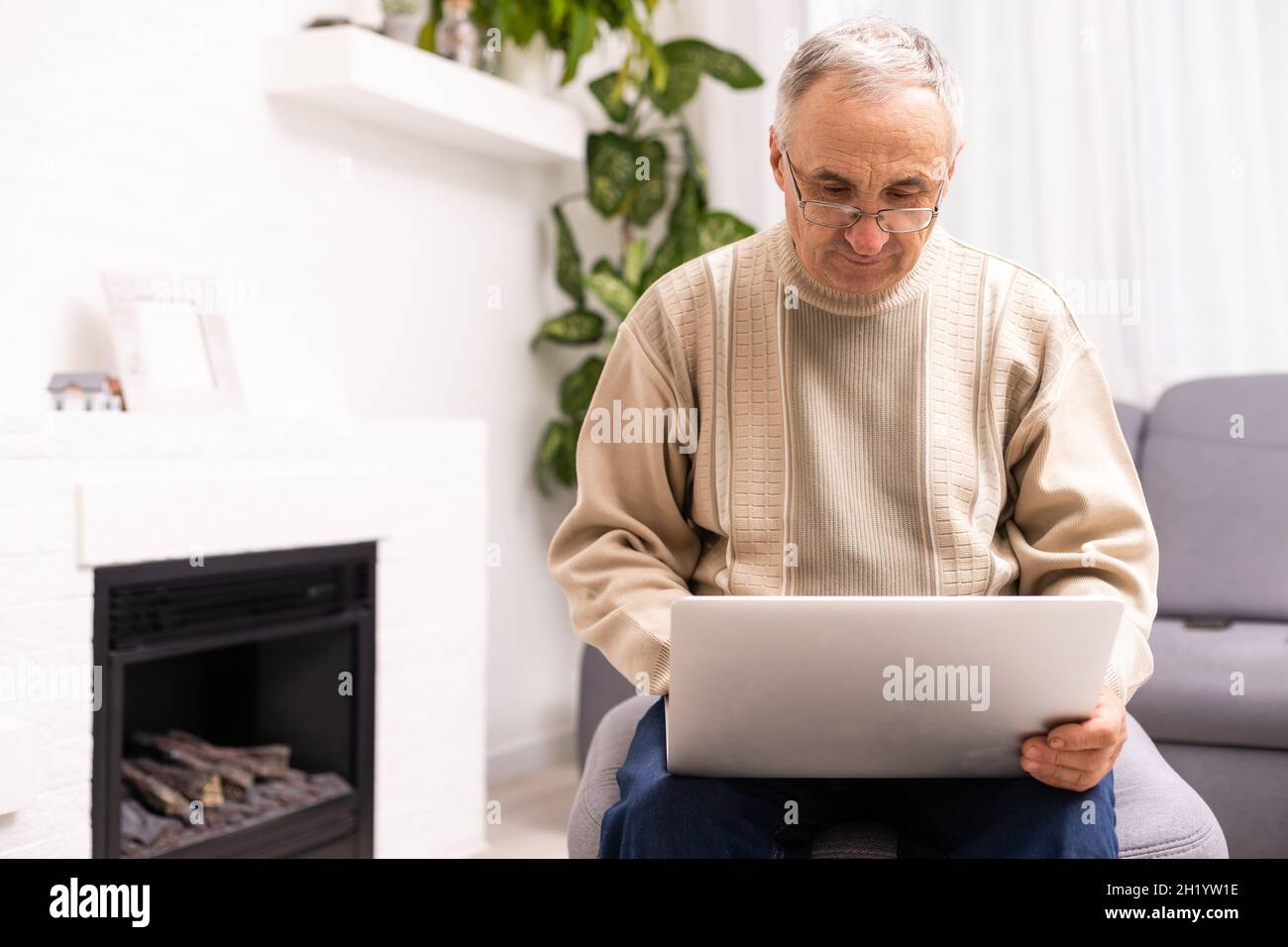 Senior working on a laptop, elderly man. Stock Photo