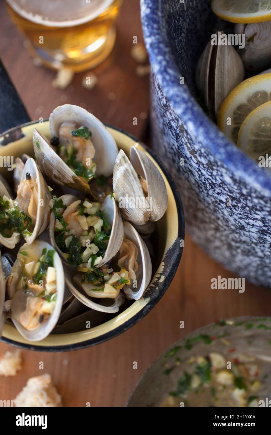 Steamed clams in a white wine broth with garlic and herbs Stock Photo