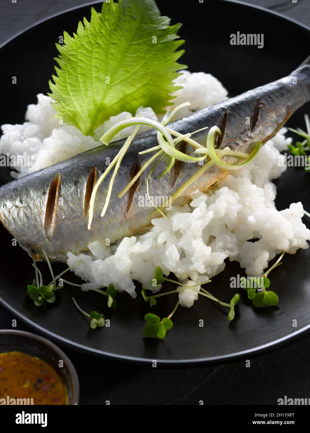 A steamed sardine on rice with a shiso leaf Stock Photo Alamy