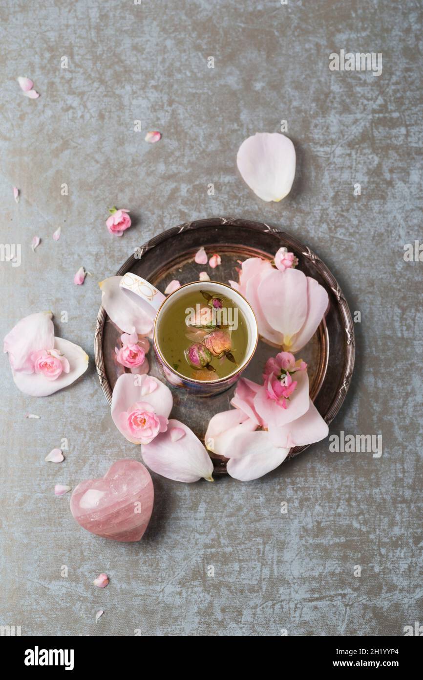 Rose blossom tea, rose quartz and rose petals Stock Photo