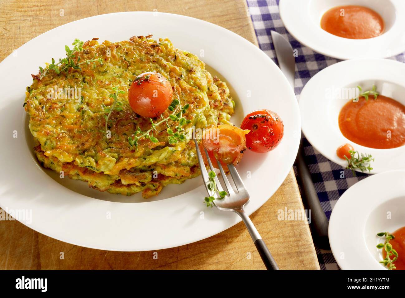 Feta cheese fritters with cherry tomatoes and tomato soup Stock Photo