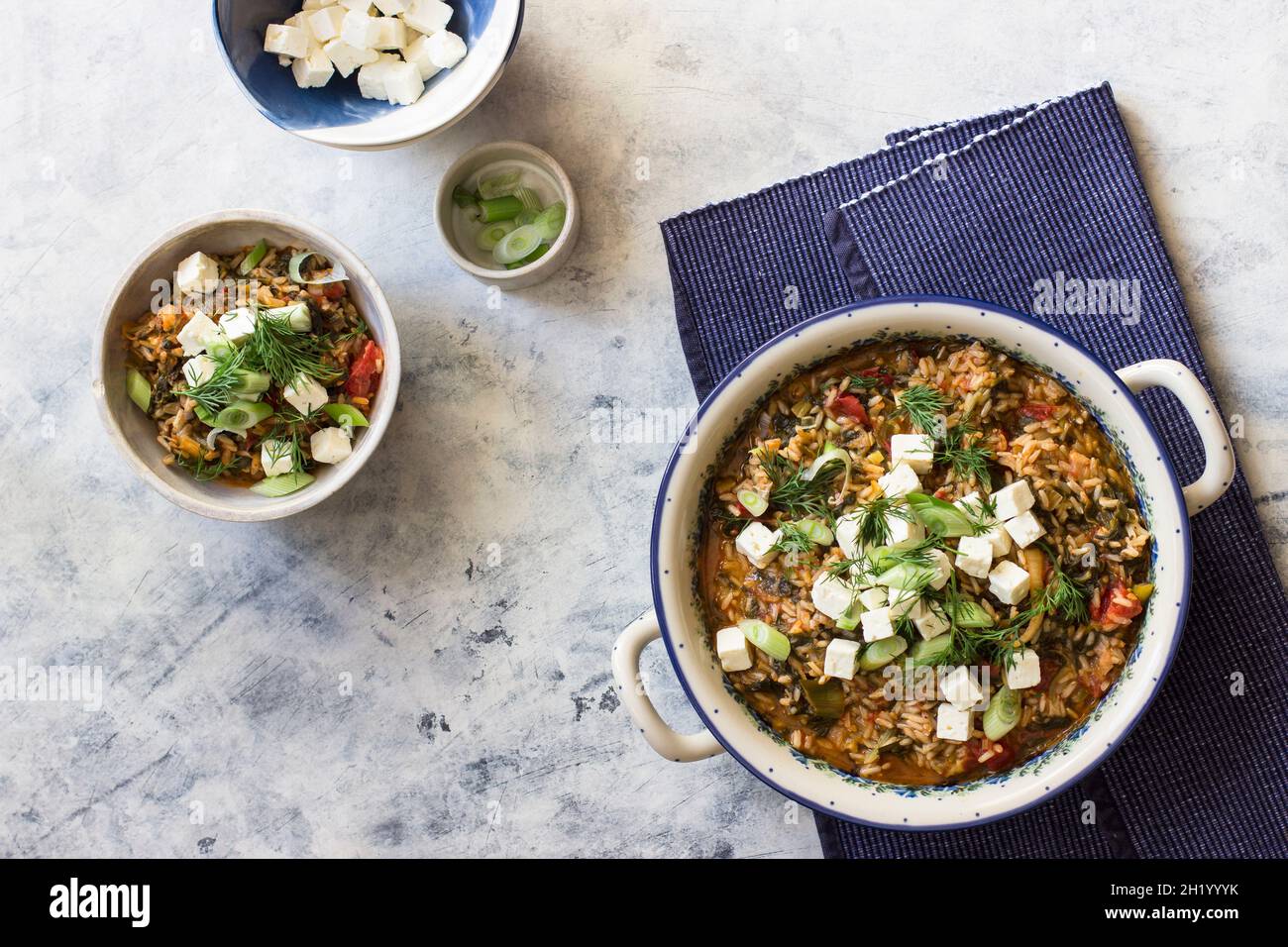 Spanakorizo - greek rice dish with spinach, tomatoes and feta Stock