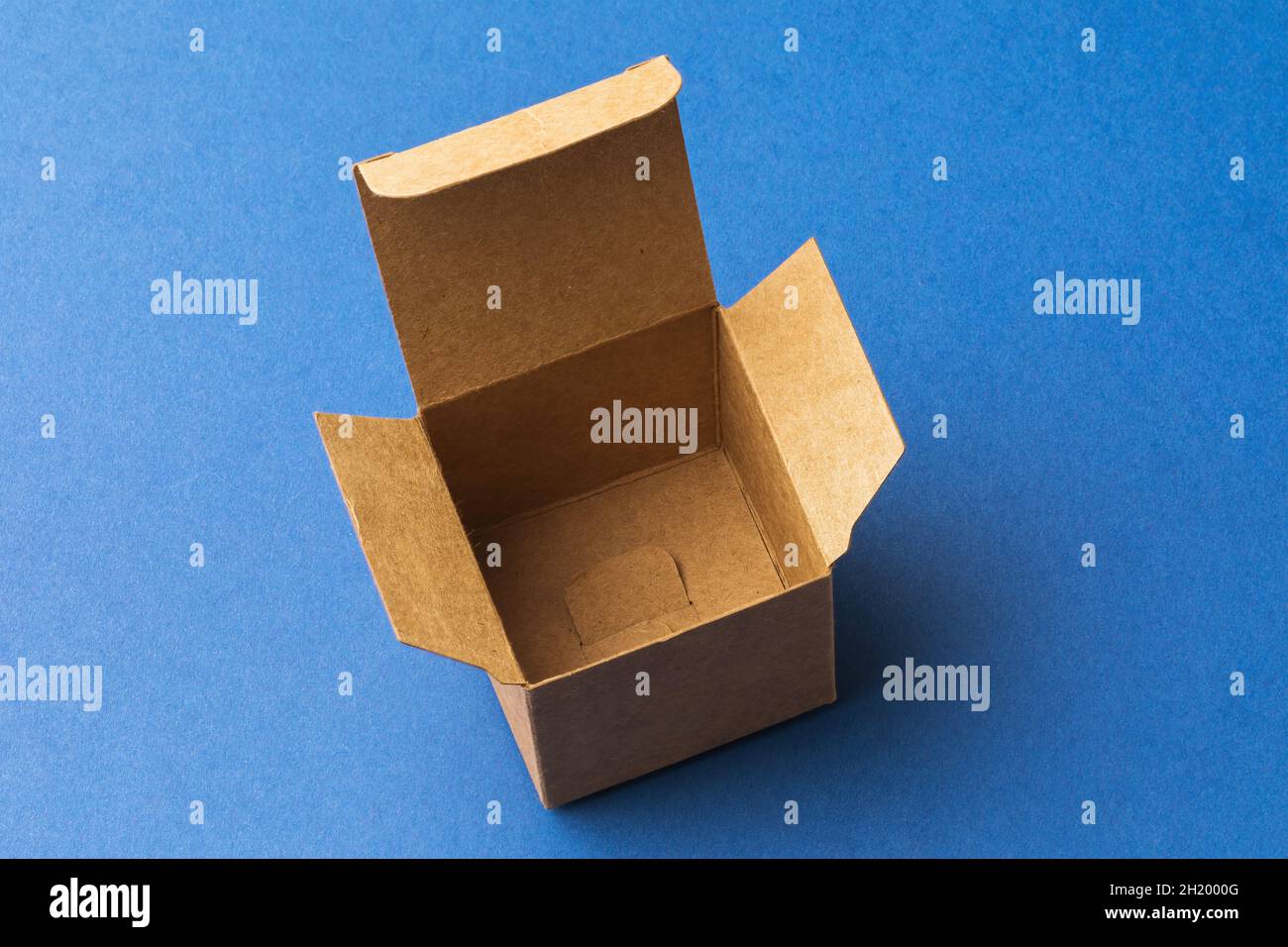 Empty open cardboard box on blue background, template for designers Stock Photo