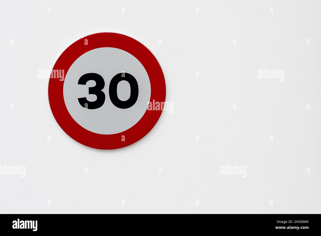 Forbidden sign to circulate more than 30 km-h, on a white background ...