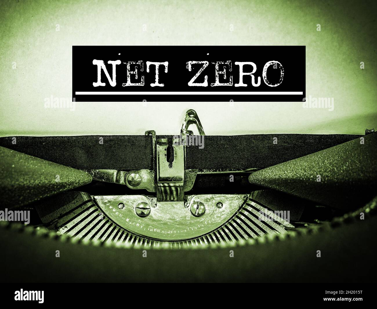 Net Zero displayed on a vintage typewriter with underline text and black border in a green tone Stock Photo