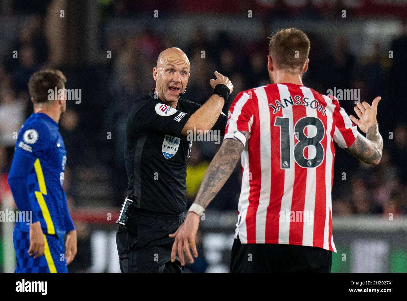 Referee Anthony Taylor and Brentford Pontus Jansson during the Premier League match between Brentford and Chelsea at the Brentford Community Stadium, Brentford, England on 16 October 2021. Photo by Andrew Aleksiejczuk / PRiME Media Images. Stock Photo
