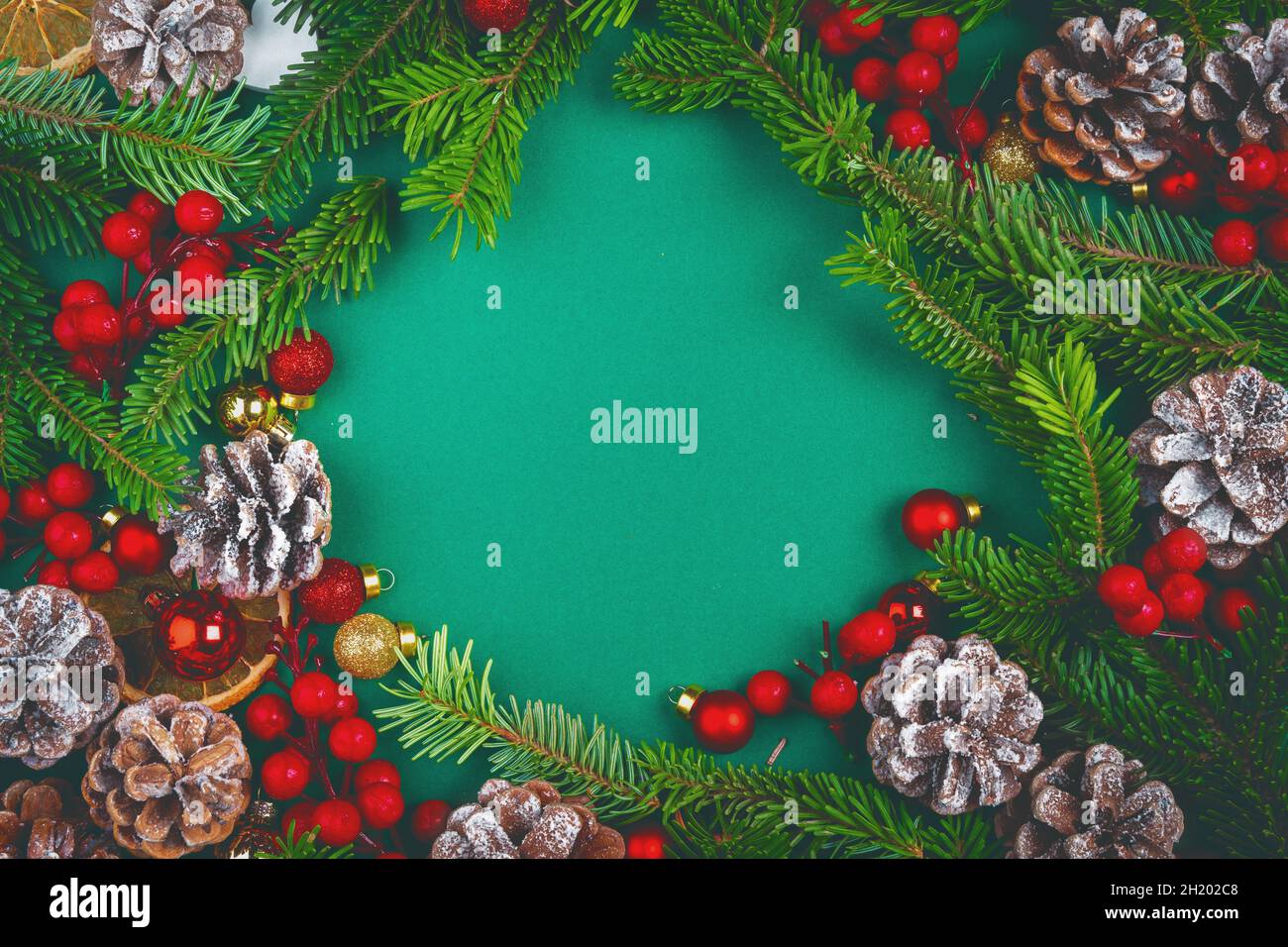 Christmas background with cones and pine branches on green Stock Photo ...