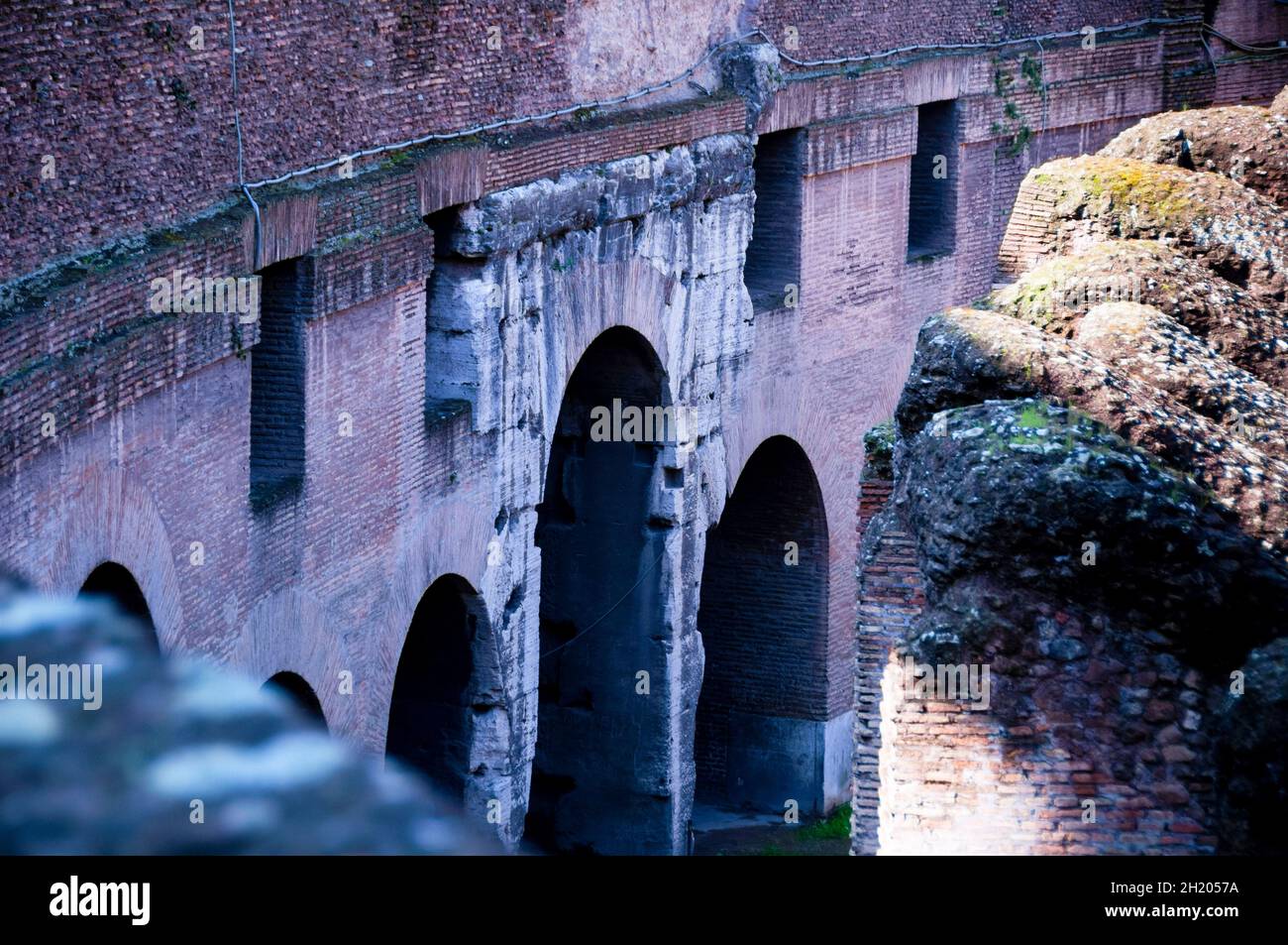 Travertine limestone and brick-faced concrete of the Roman Colosseum in Rome, Italy. Stock Photo
