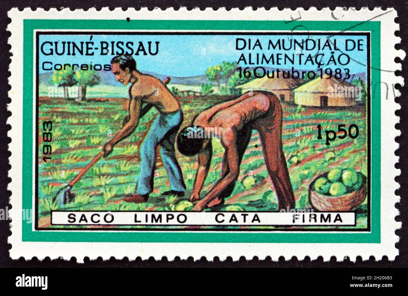 GUINEA-BISSAU - CIRCA 1983: a stamp printed in Guinea-Bissau dedicated to the World Food Day, People Working in the Field, circa 1983 Stock Photo