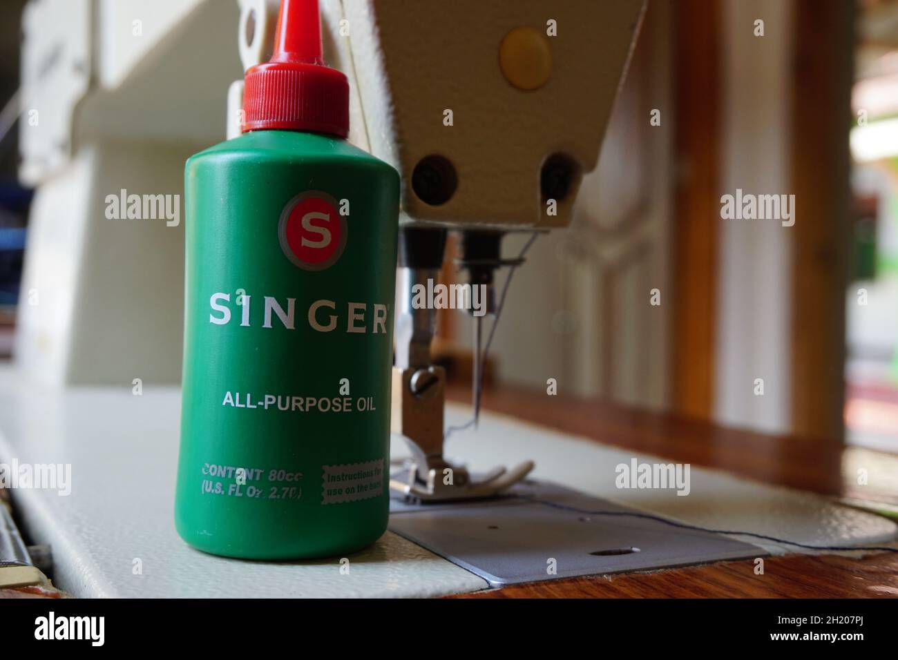Green a bottle of lubricant for sewing machine Stock Photo Alamy