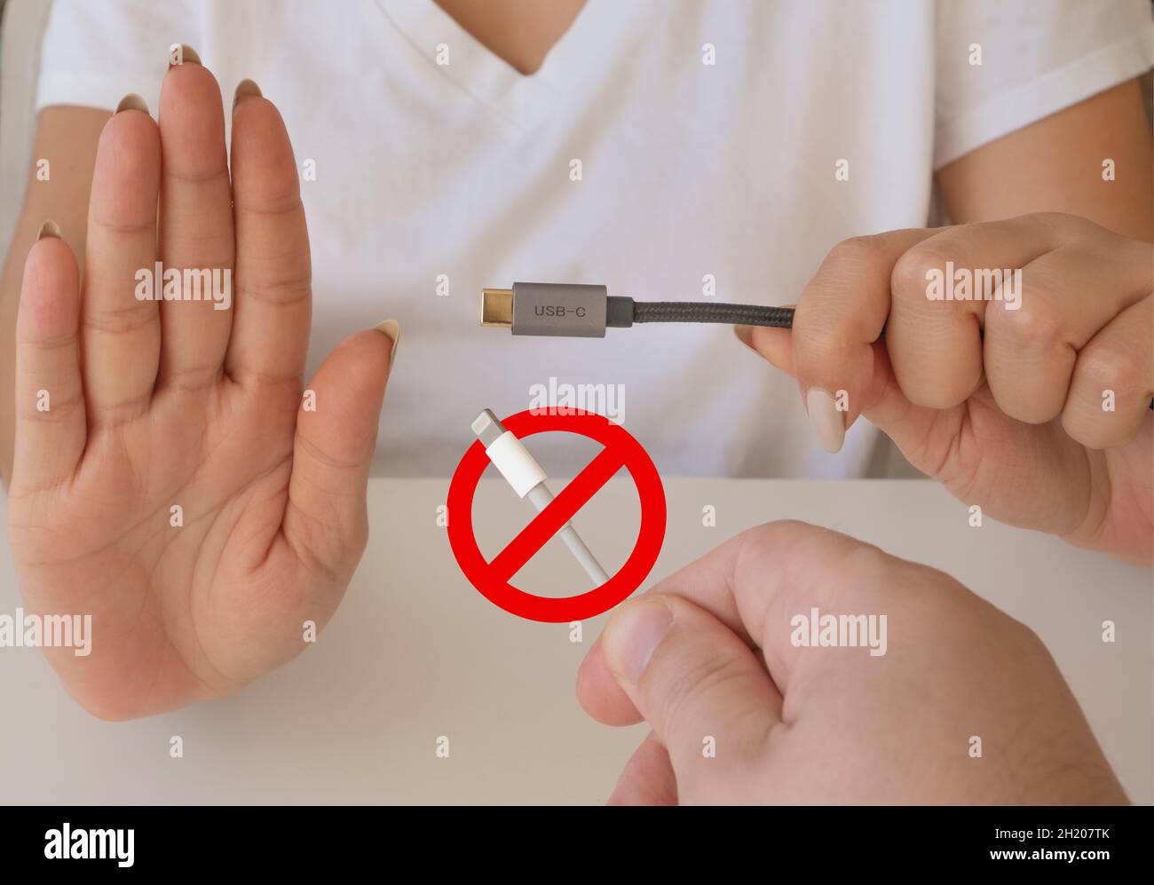 European union bans lightning cable. Hand trying to plug typec cable