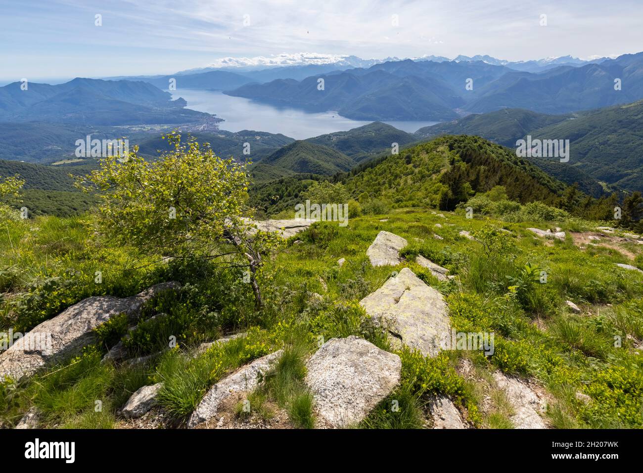 View of Lake Maggiore and piedmont mountains from the top of Monte Lema. Dumenza, Varese district, Lombardy, Italy. Stock Photo