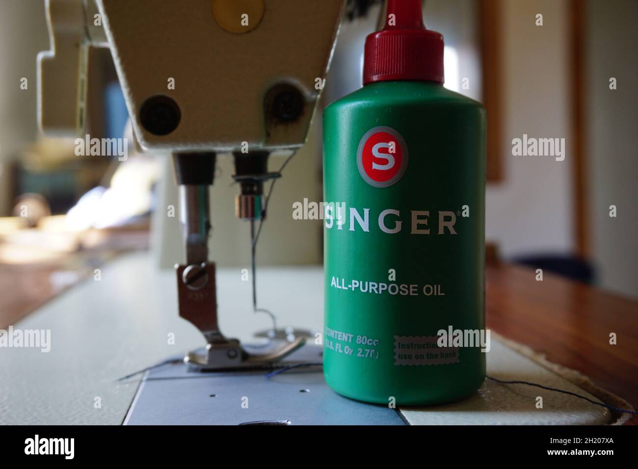 Green a bottle of lubricant for sewing machine Stock Photo Alamy