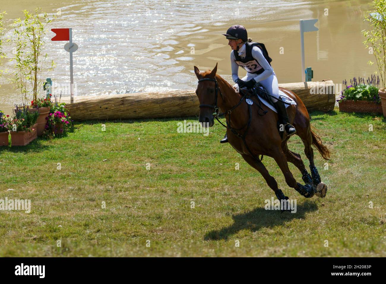 Horse and rider takling the cross country course and water jumps at an