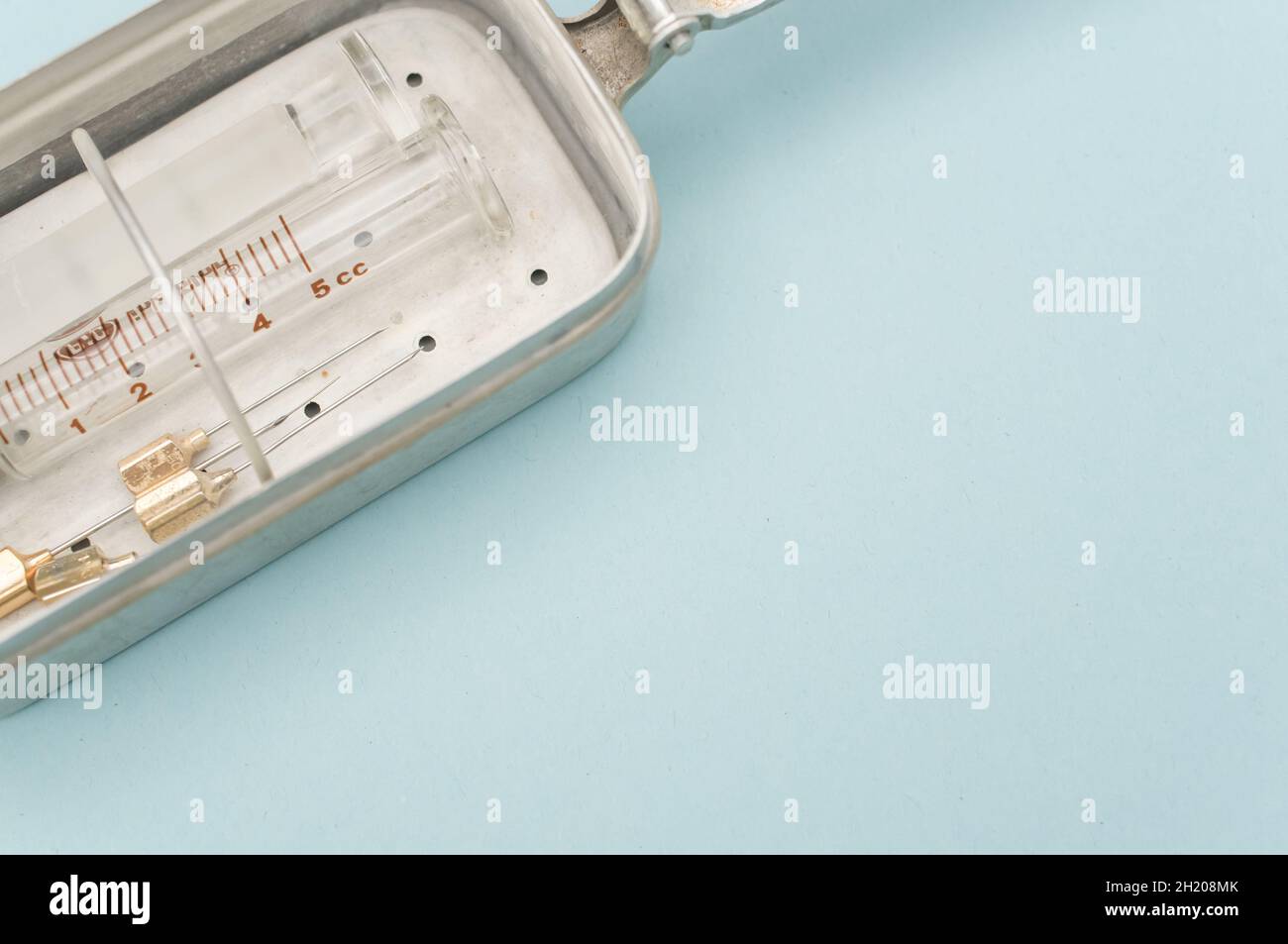 isolated sterilized glass injection syringe in a box on a blue Stock ...