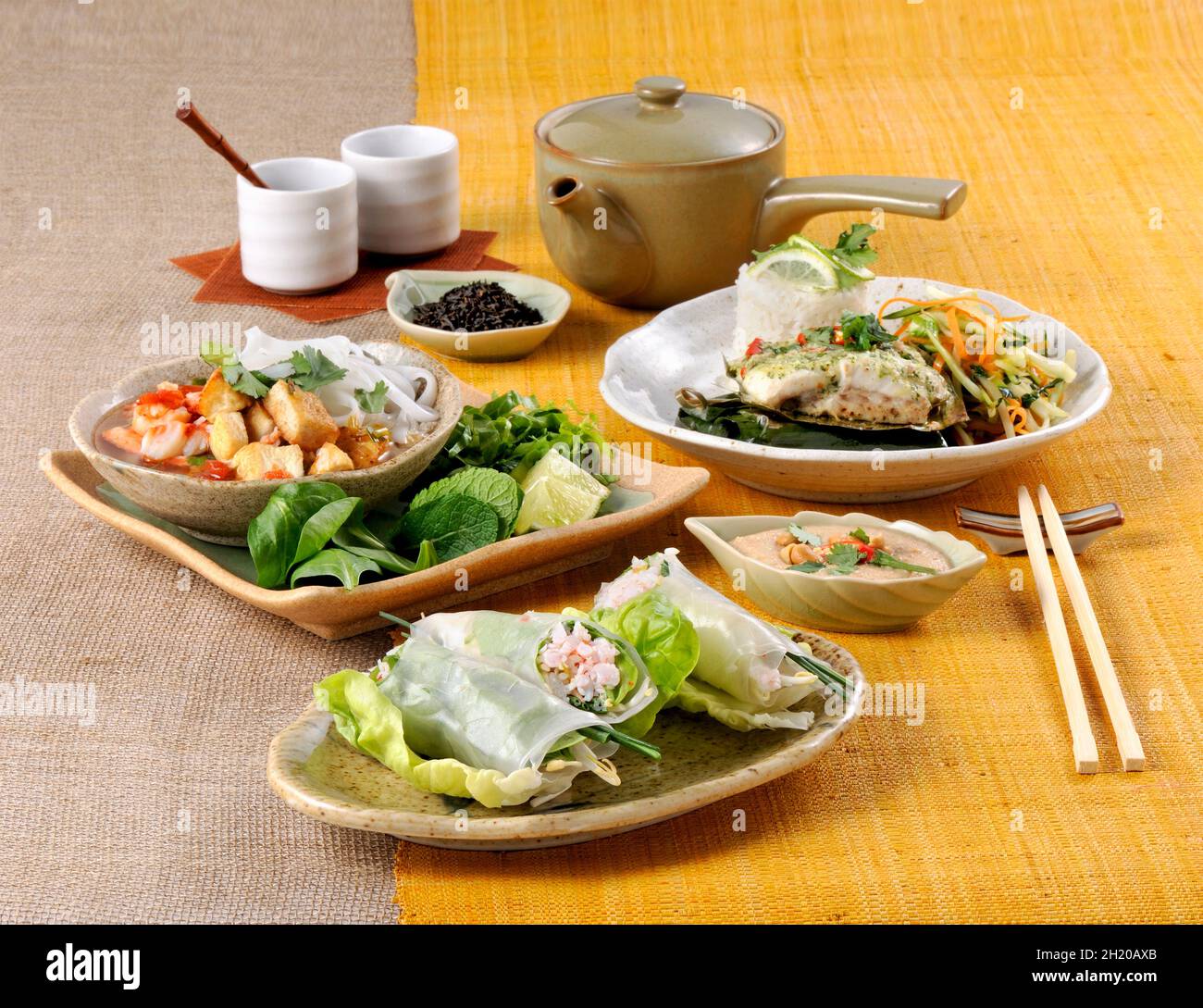 Various Thai dishes on a yellow table runner Stock Photo
