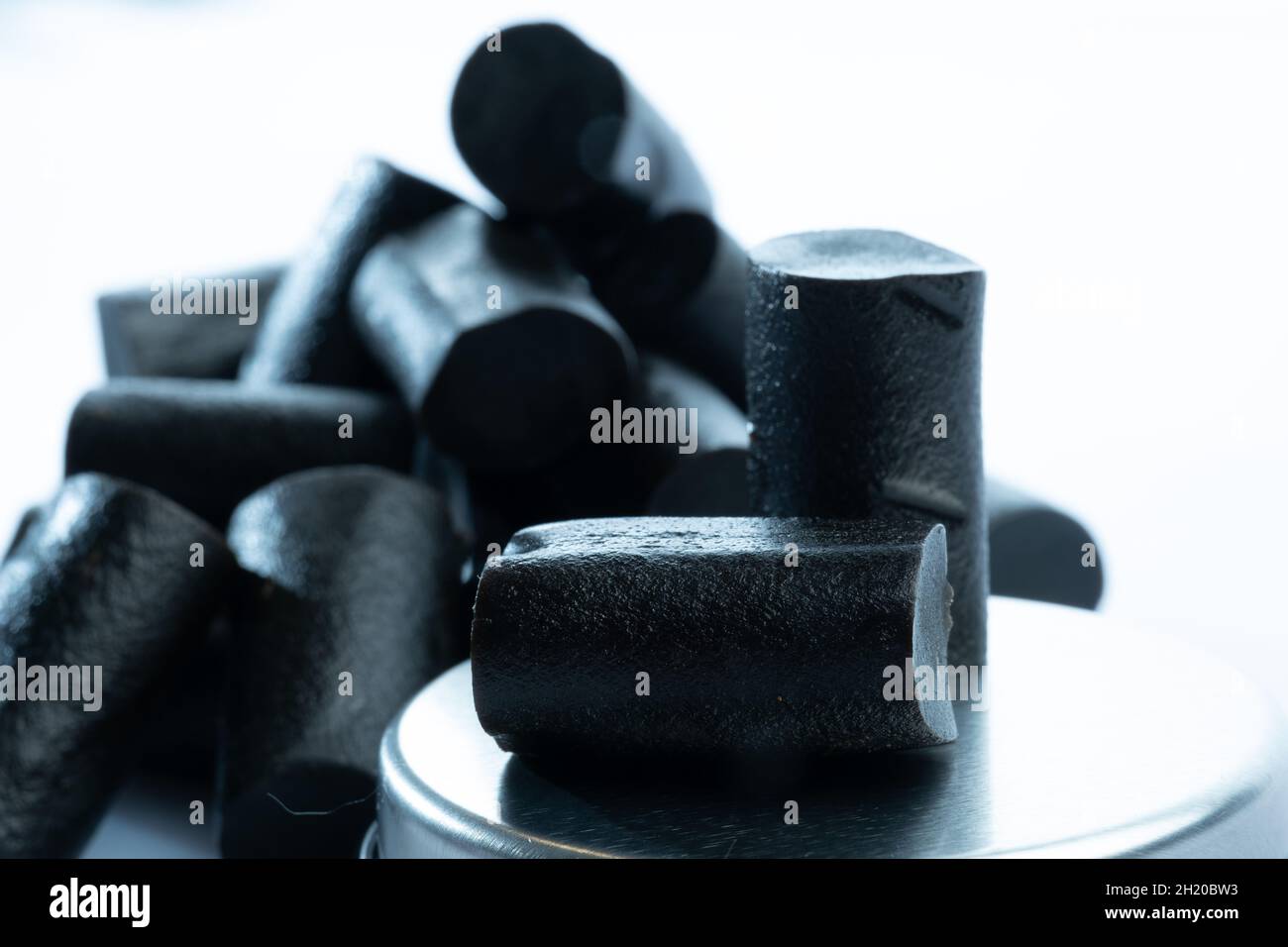 Helsinki / Finland - OCTOBER 19, 2021: Closeup of a bunch of Finnish black liqourice against bright white background Stock Photo