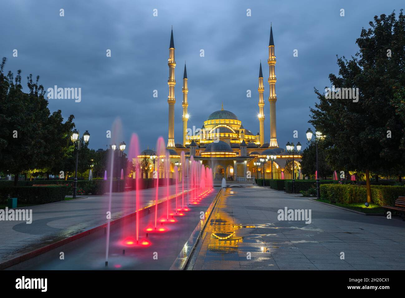 Mosque 'Heart of Chechnya' and alley of fountains in the evening illumination. Grozny, Chechen Republic Stock Photo
