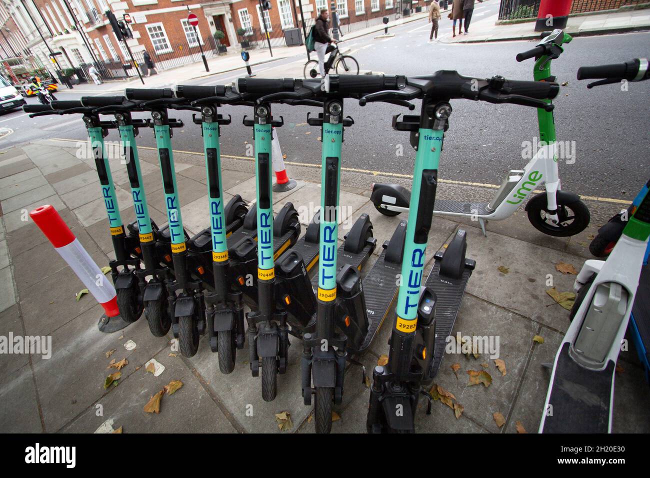 Tier and Lime Electric Scooters for hire in Mayfair London street Stock Photo Alamy