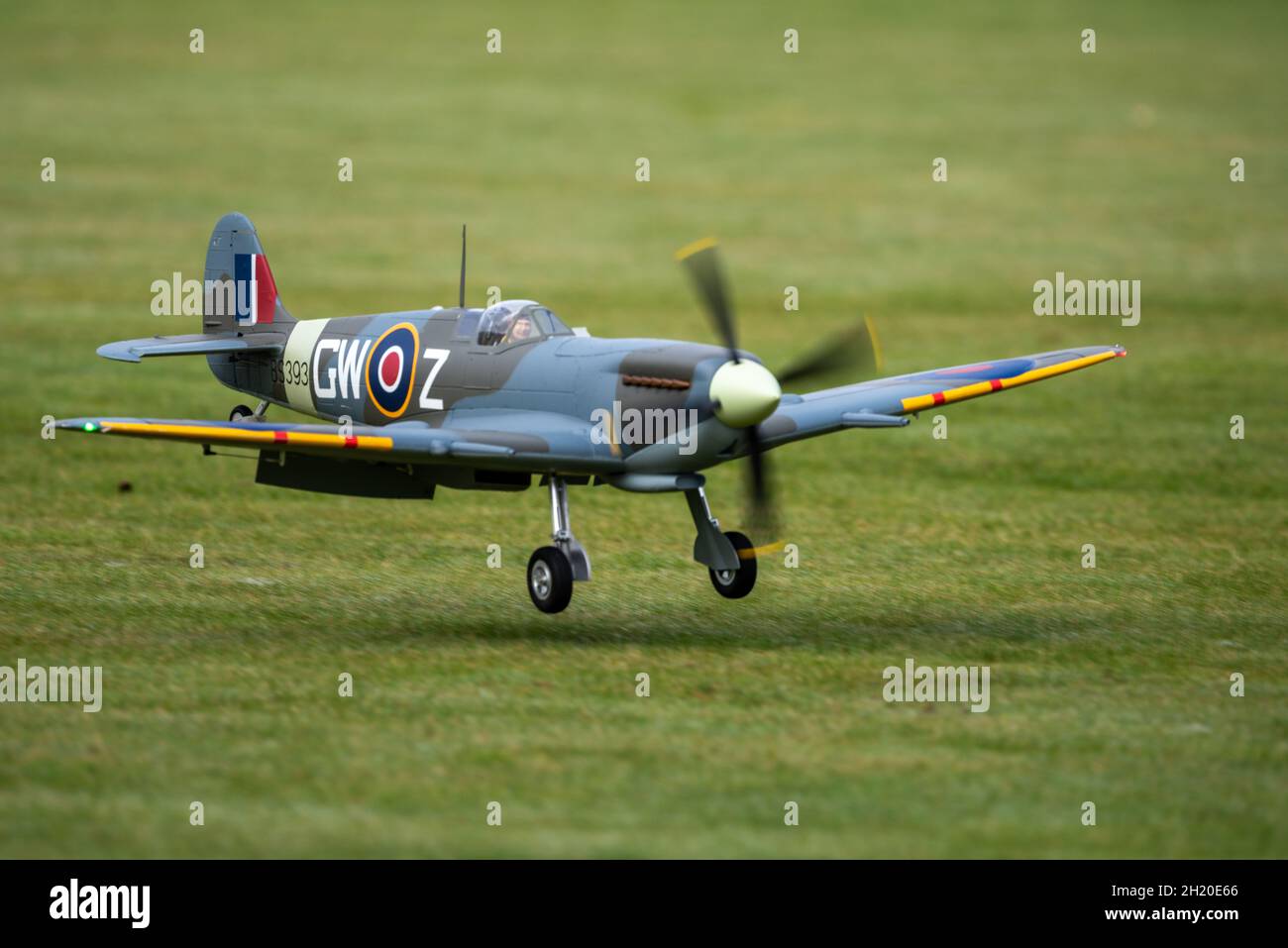 A RC model Spitfire landing at the Basingstoke Model Aero Club, Basingstoke, UK Stock Photo