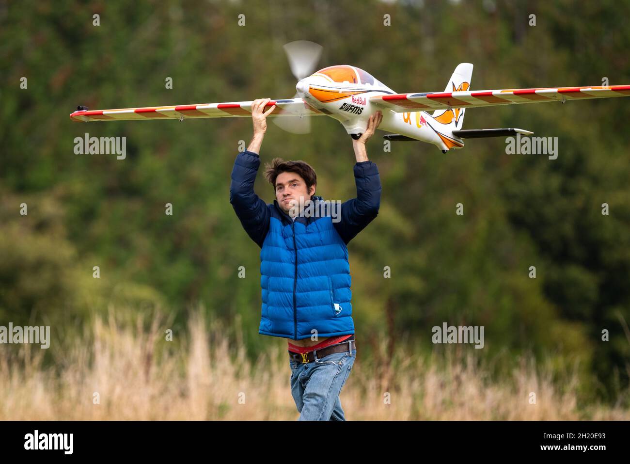 A large motorised radio-control glider is launched by hand at the Basingstoke Model Aero Club, Basingstoke, UK Stock Photo