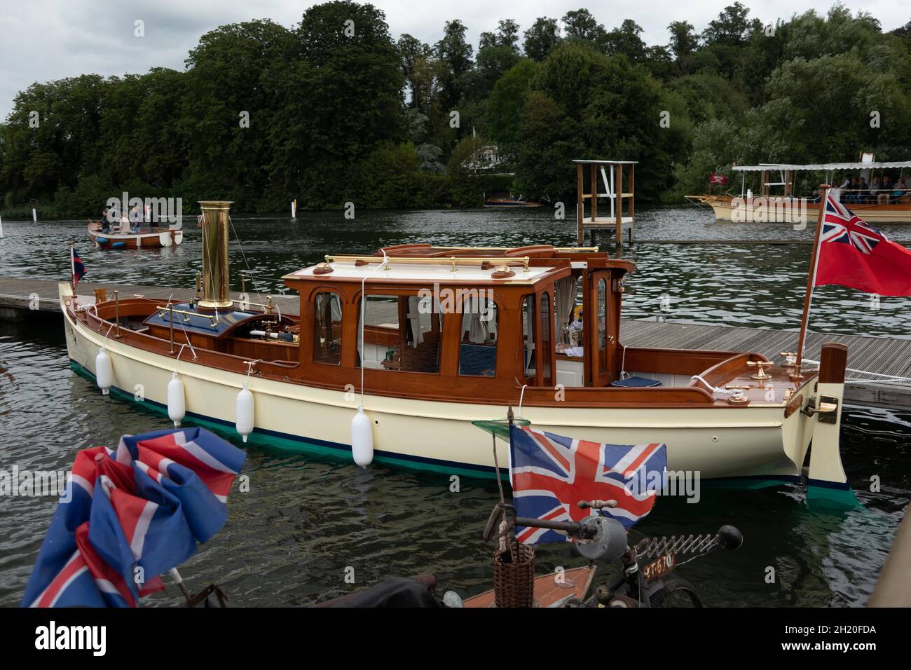 Vintage Steam boat at the Thames Traditional Boat Festival at Henley Upon Thames England with red ensign and union flags flown Stock Photo