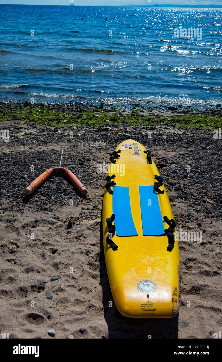 Yellow Rescue surfboard paddle board on beach at Leven Fife Scotland Stock Photo