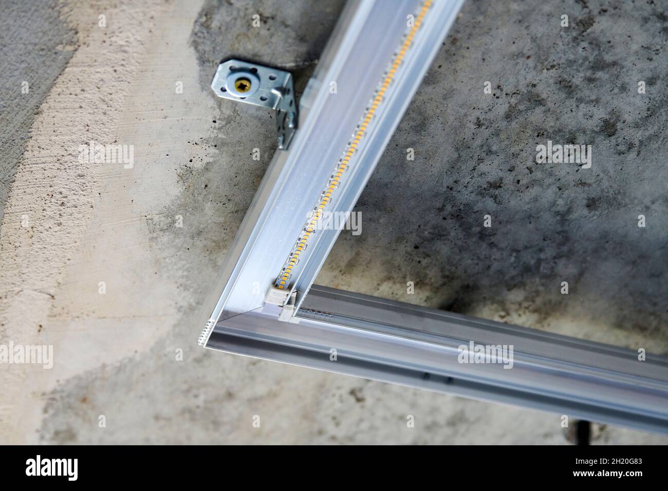 LED strip with aluminum profile on rough wall. Concrete ceiling with