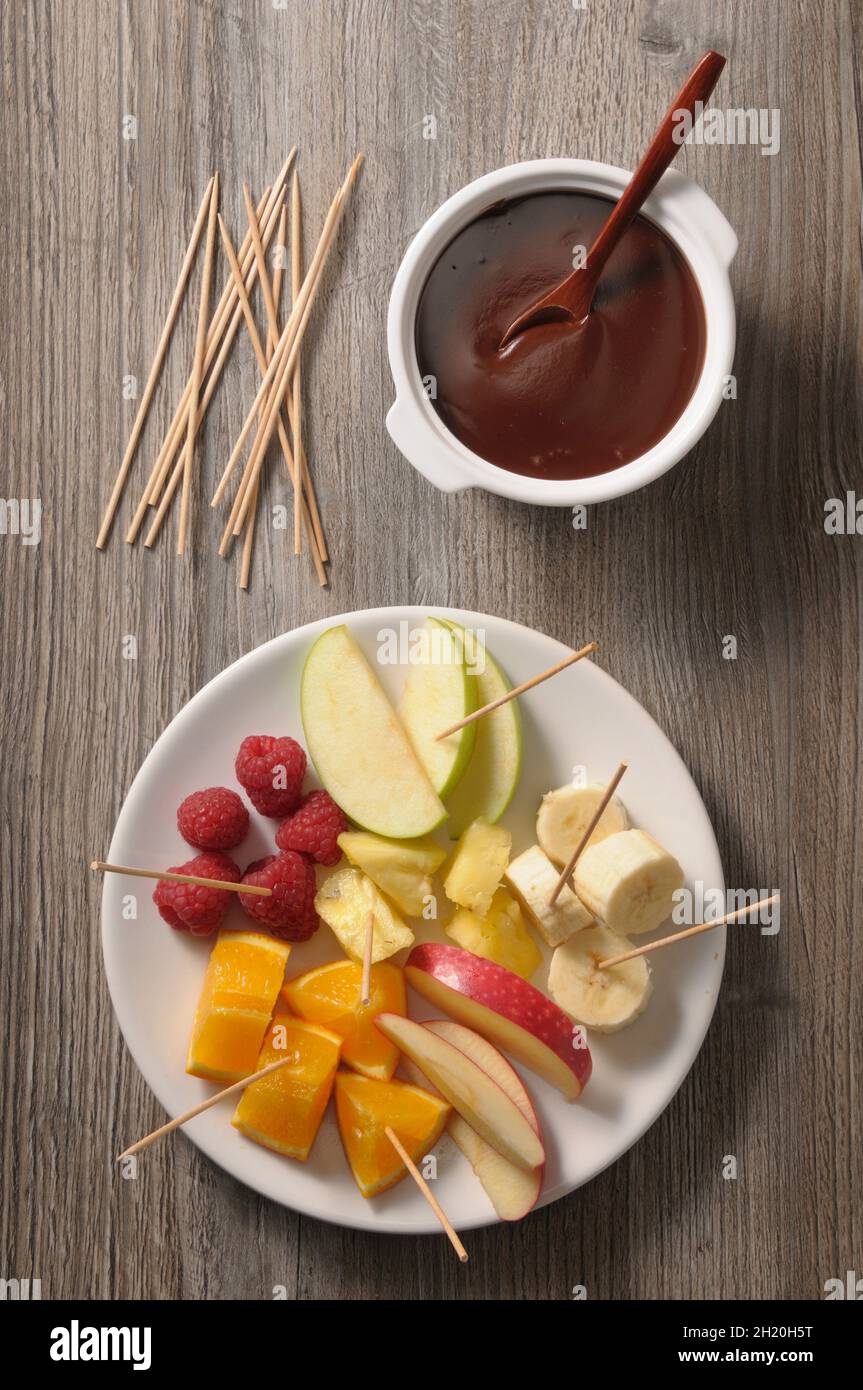 Chocolate fondue with various fruit skewers Stock Photo Alamy